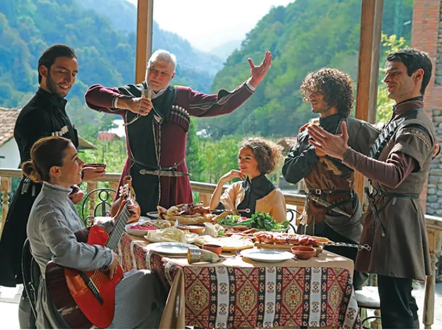 A traditional Georgian Supra feast with wine and dishes, showcasing the legendary hospitality and culture that make tourism in Georgia a world-class experience for those who visit Georgia.
